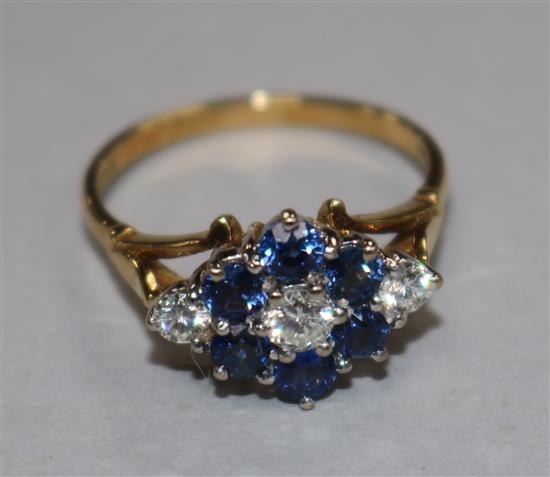An 18ct gold sapphire and diamond cluster ring, size P/Q.